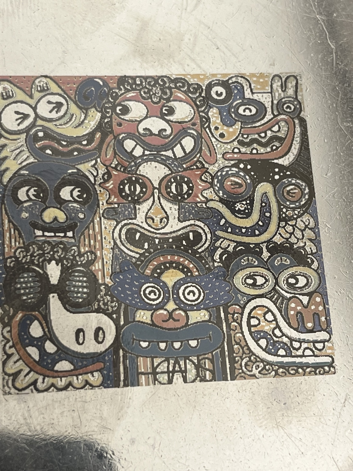 Colorful character artwork engraved on stainless steel