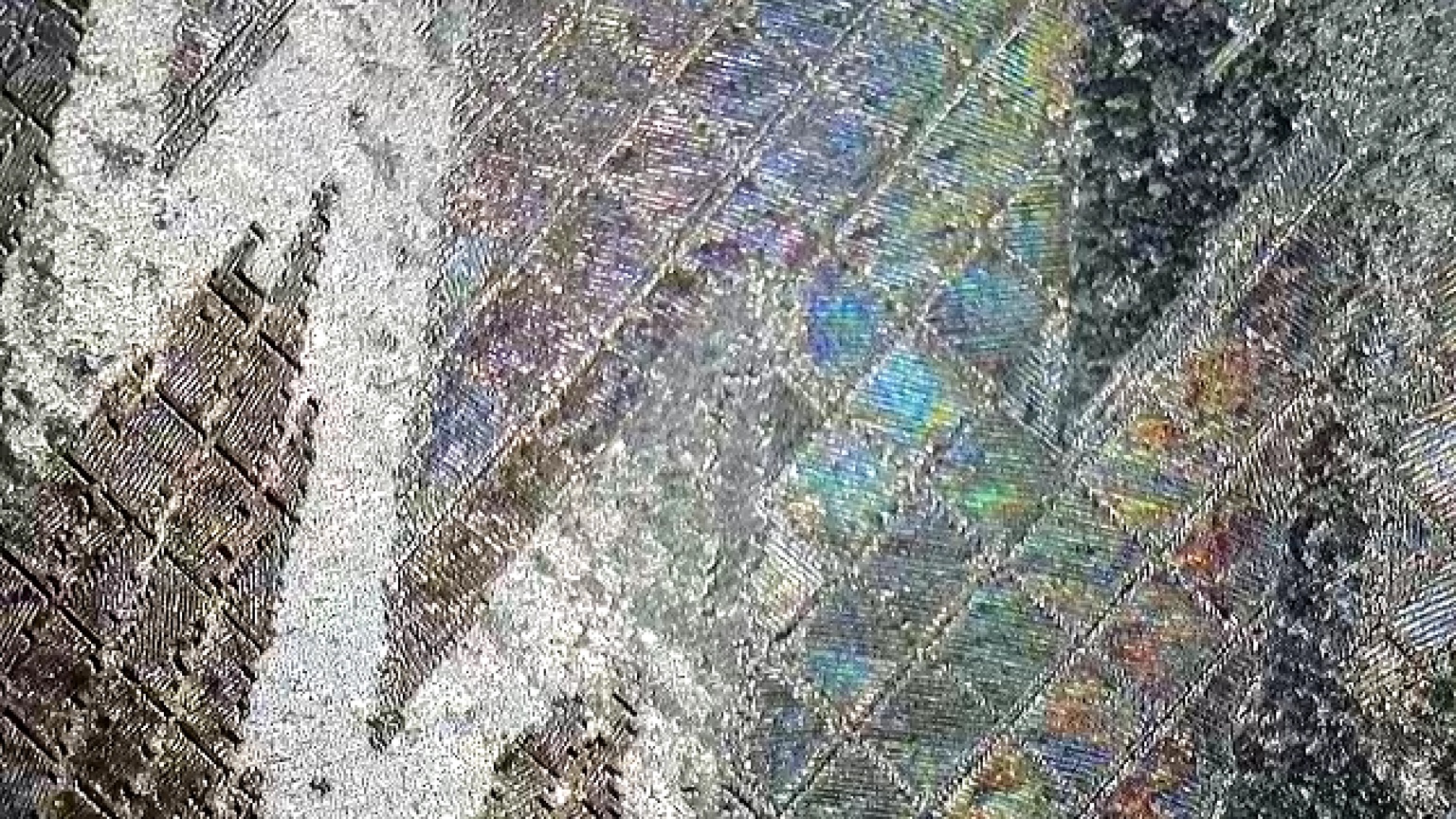 Close view of iridescent geometric laser engraving